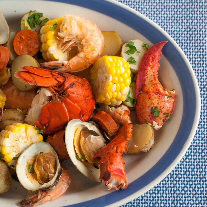 Clambake platter with lobster, clams, shrimp, corn and potatoes